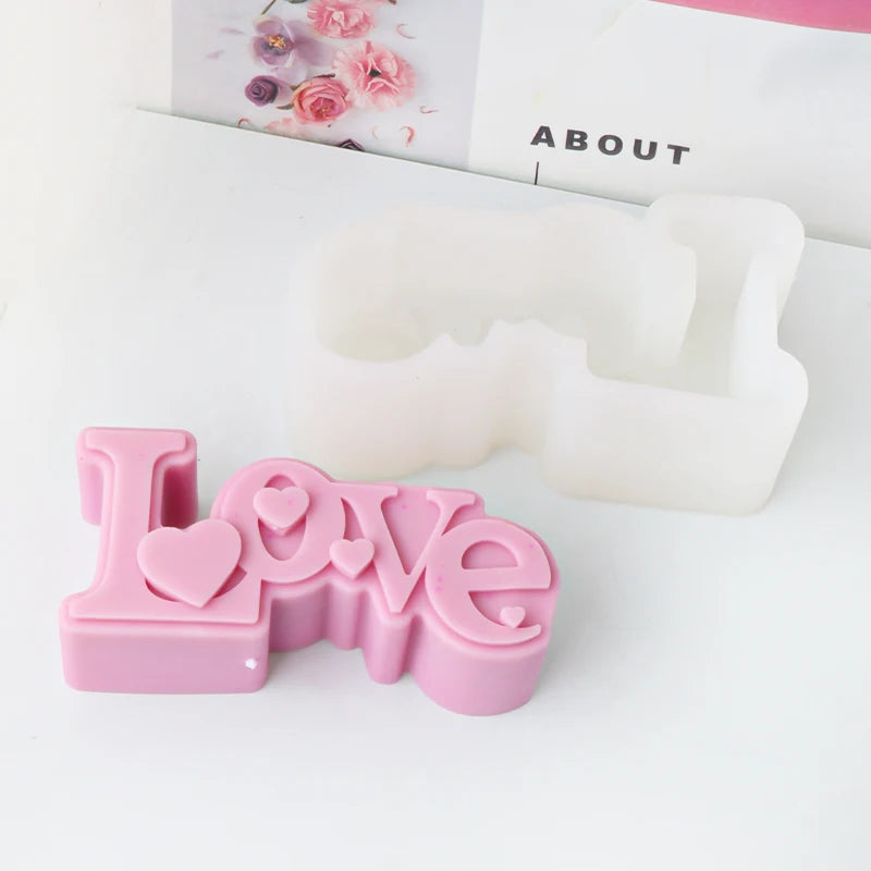Pink Love lettering casting example with heart accents beside its white silicone mold