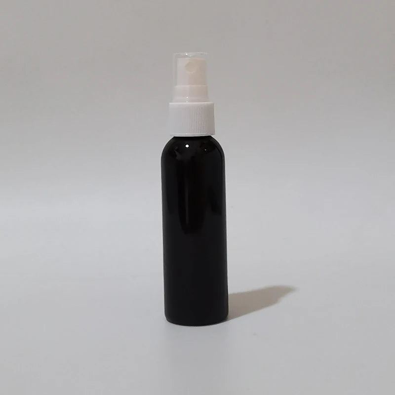 Black round spray bottle with white sprayer and clear protective cap