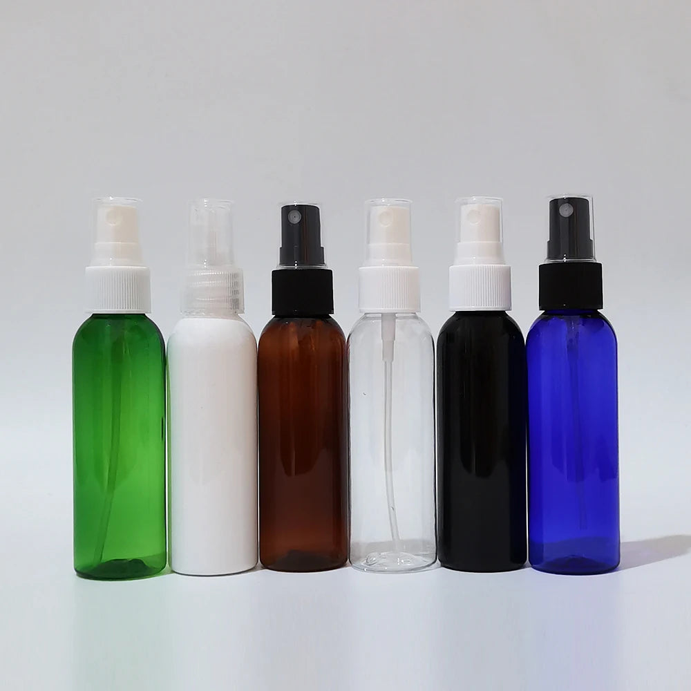 Six colored round spray bottles arranged in a row with black, white and clear sprayers