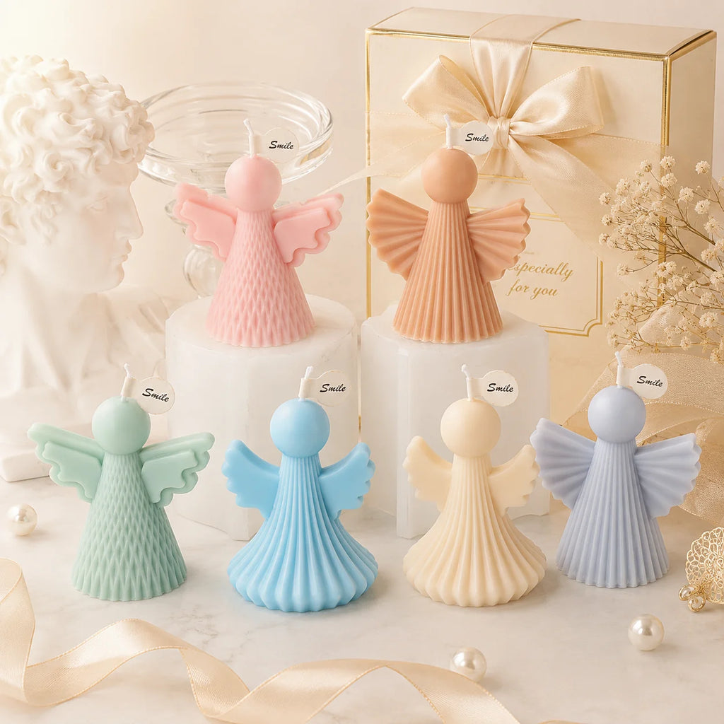Six pastel angel example candles arranged at different heights beside a gift box