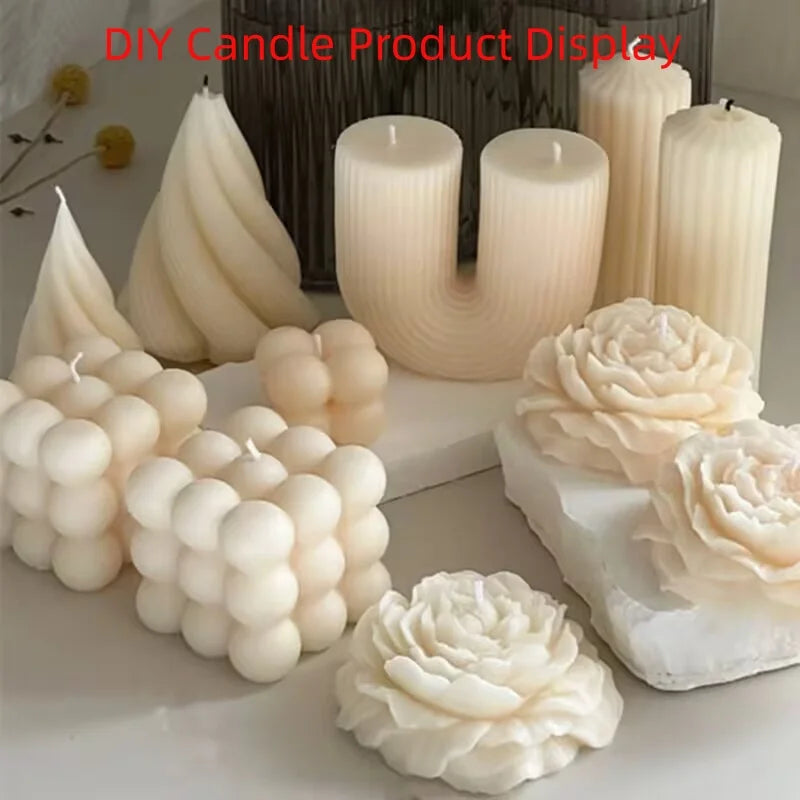 A collection of cream-colored wax candles in various shapes, including ribbed pillar candles, grape cluster candles, spiral candles, and rose-shaped candles, displayed on a light surface with a dark textured container in the background. Red text at the top reads 'DIY Candle Product Display'.