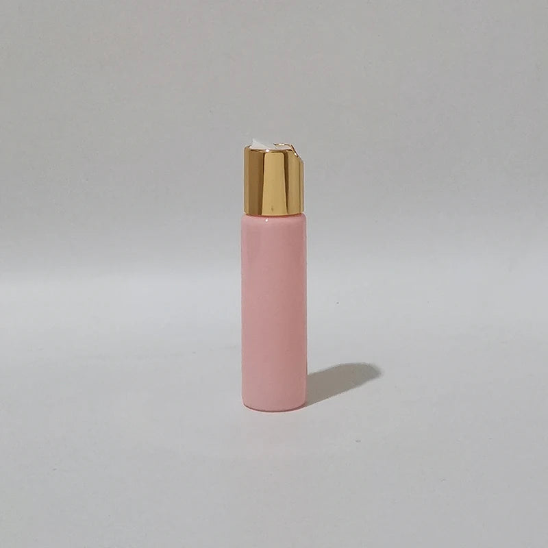 Pink PET bottle with gold-tone disc-top cap and white insert, pink-2