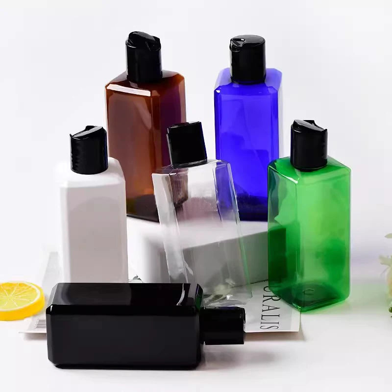 Square bottles in assorted colors with black disc-top caps