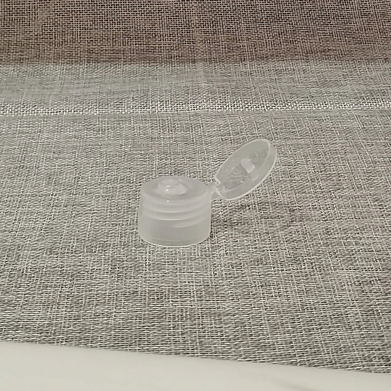 Clear plastic screw-on flip-top bottle cap shown open
