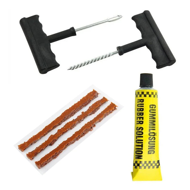 Tire repair kit with rubber strips, a tube of rubber solution, and tools on a white background