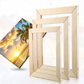 Set of wooden picture frame stretcher bars with a beach scene photo on a white background