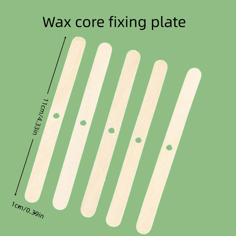 Five light wood popsicle sticks arranged diagonally on a green background, with text reading 'Wax core fixing plate' and dimension arrows indicating 11 cm length and 1 cm width.