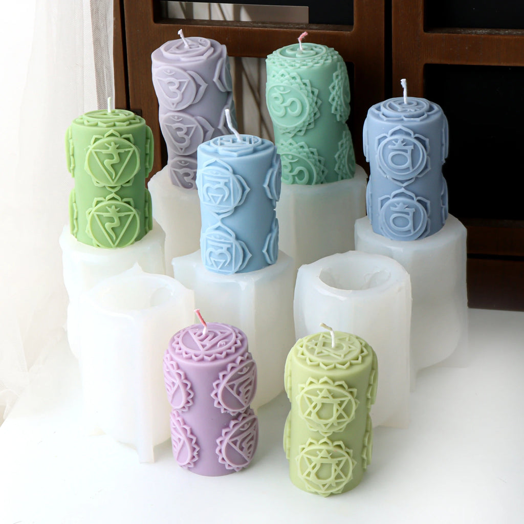 Seven patterned pillar candle examples arranged around white cylindrical silicone molds