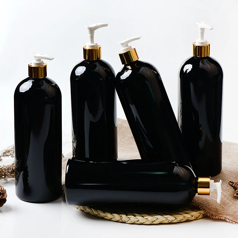 Black large PET bottles with white pumps and gold-tone collars standing and lying sideways