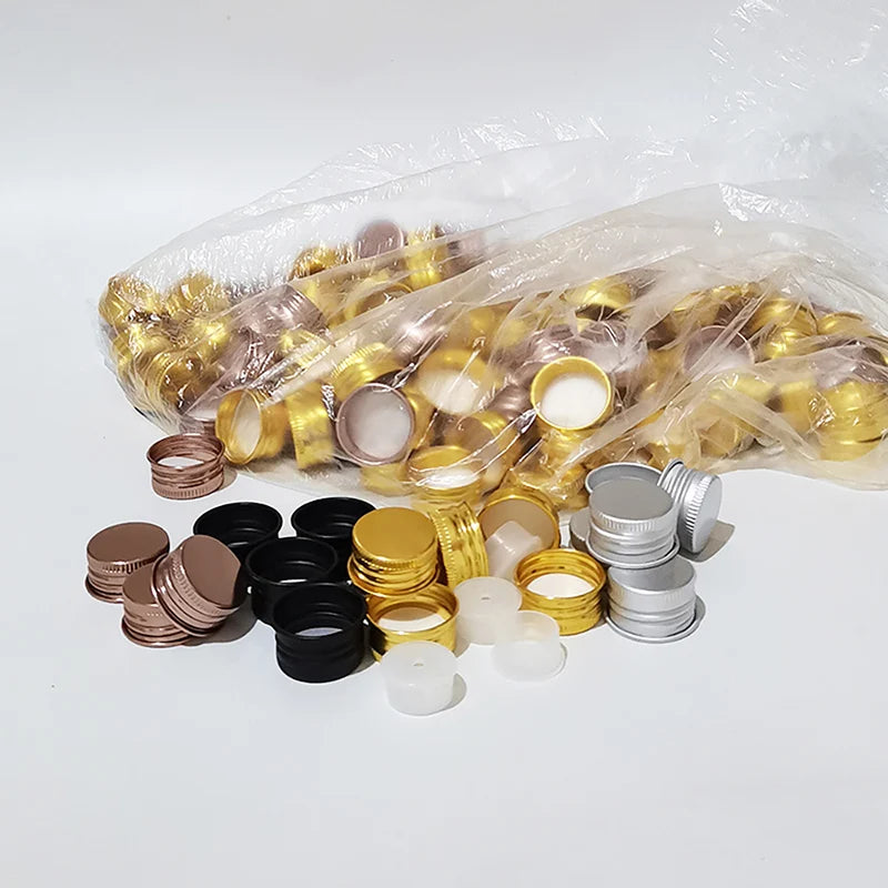 Black, gold-tone, bronze-tone and silver screw caps with separate white inner components