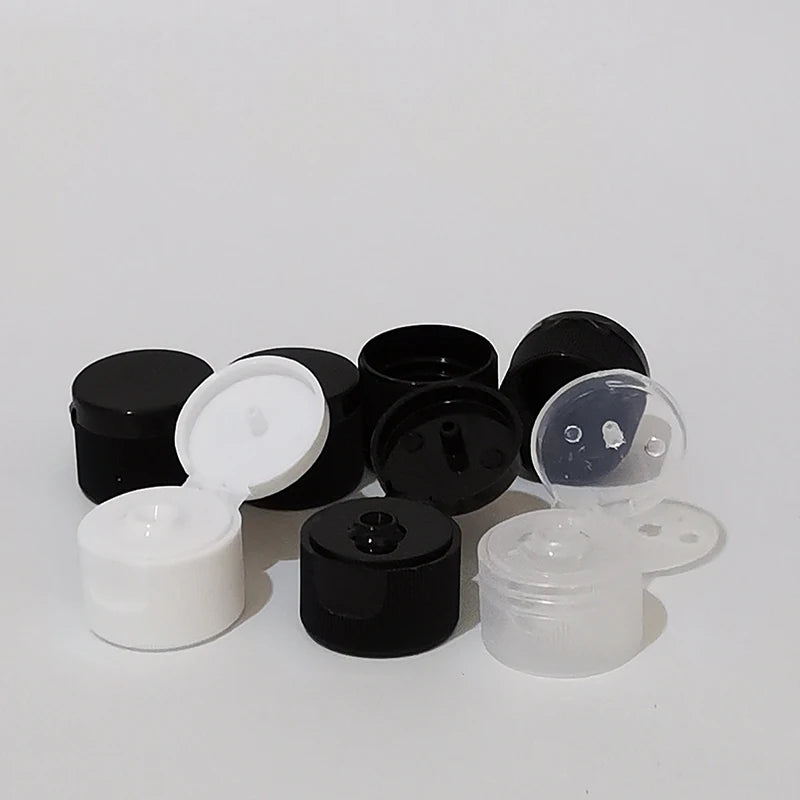 Black, white and clear flip-top bottle caps with hinged lids open and closed