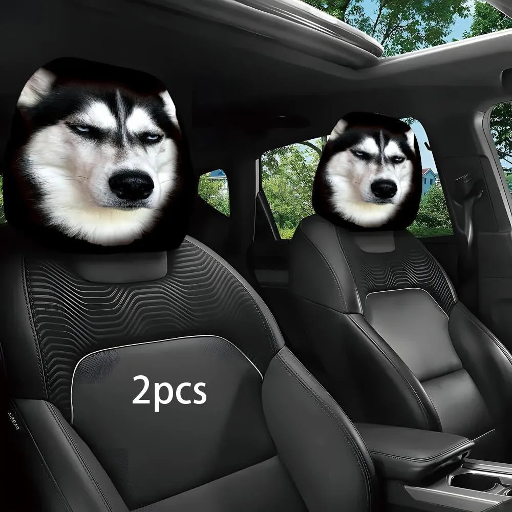 Two car headrests featuring printed husky dog faces, installed on the front seats of a black car interior. A white '2pcs' text overlay is visible on the left headrest.