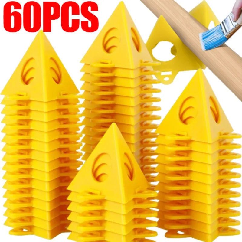Sixty yellow triangular plastic pegs stacked in groups, with a wooden pole and paintbrush shown at the top right demonstrating use, and a red '60PCS' text overlay on a white background.