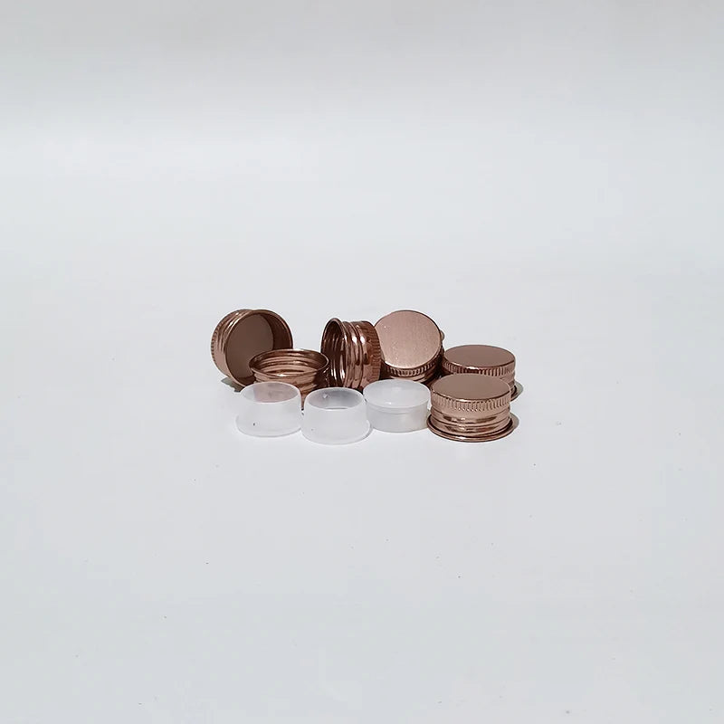 Bronze-tone screw caps beside white inner components