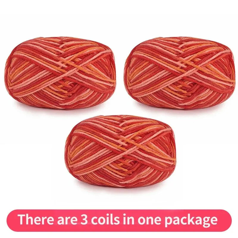 Three coral and orange tonal yarn skeins, shown as one package.