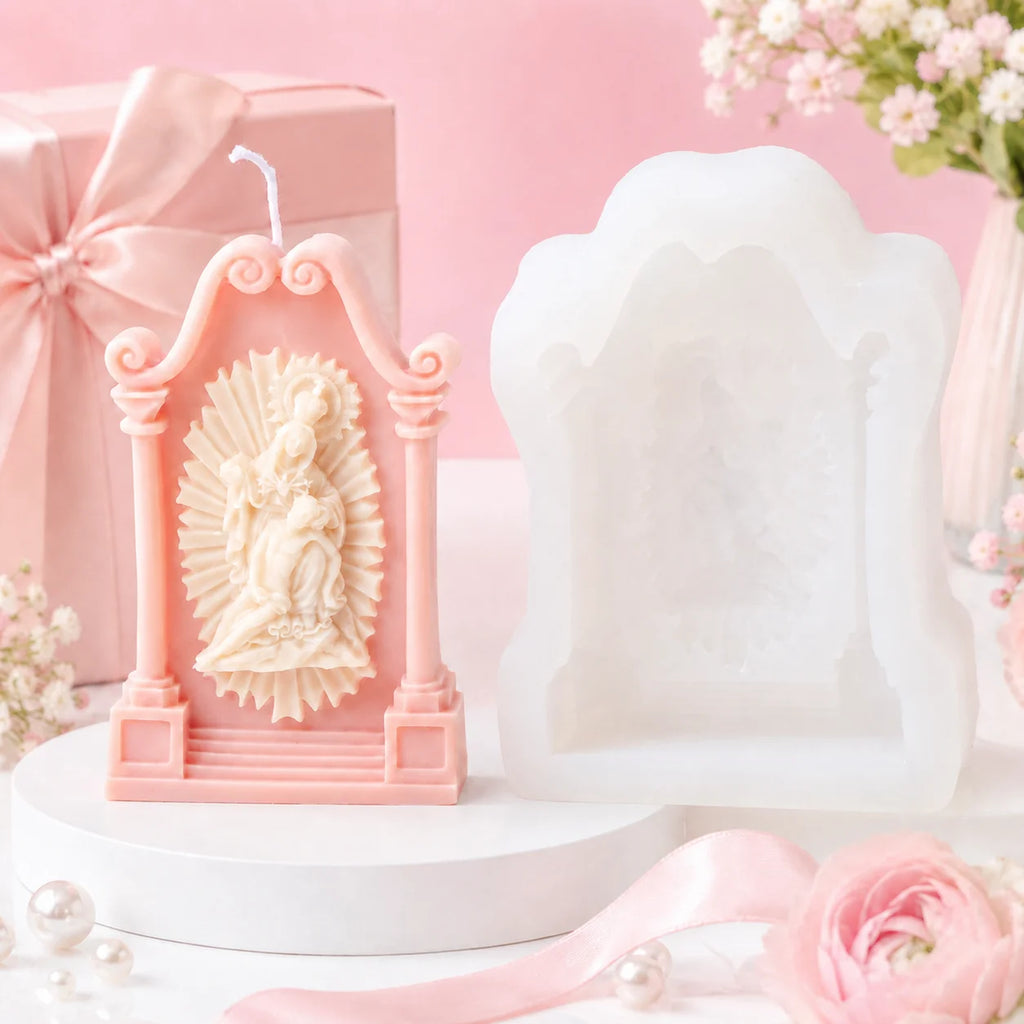 Pink shrine casting with seated mother-and-child relief beside its white silicone mold