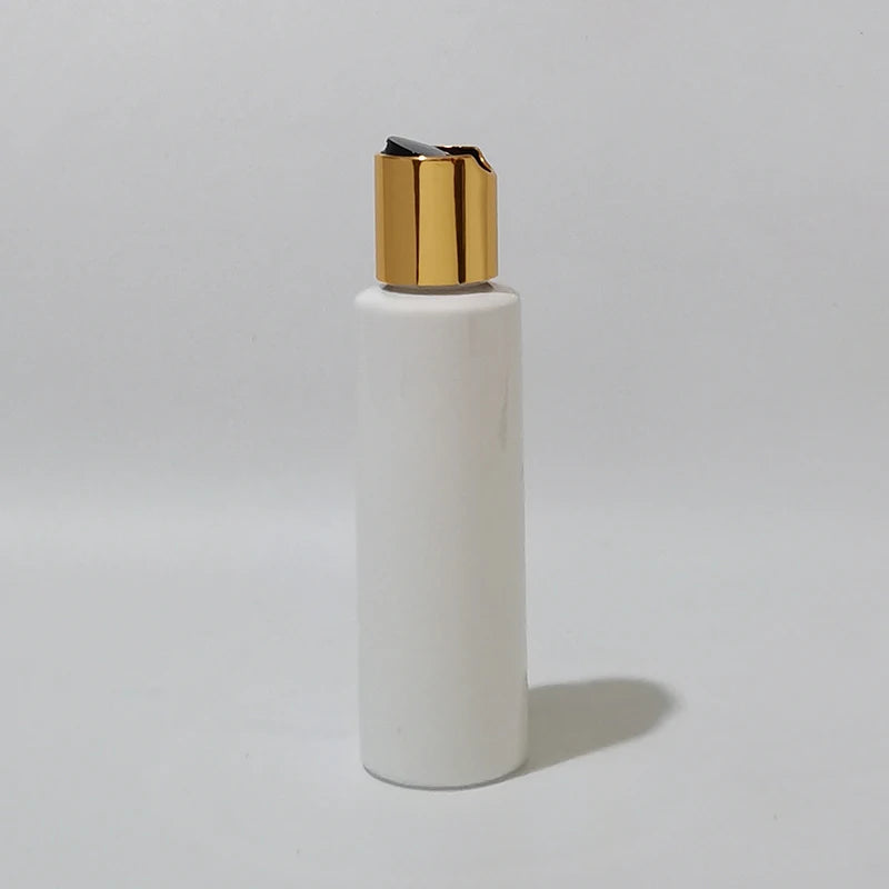 White PET bottle with gold-tone cap and black disc insert