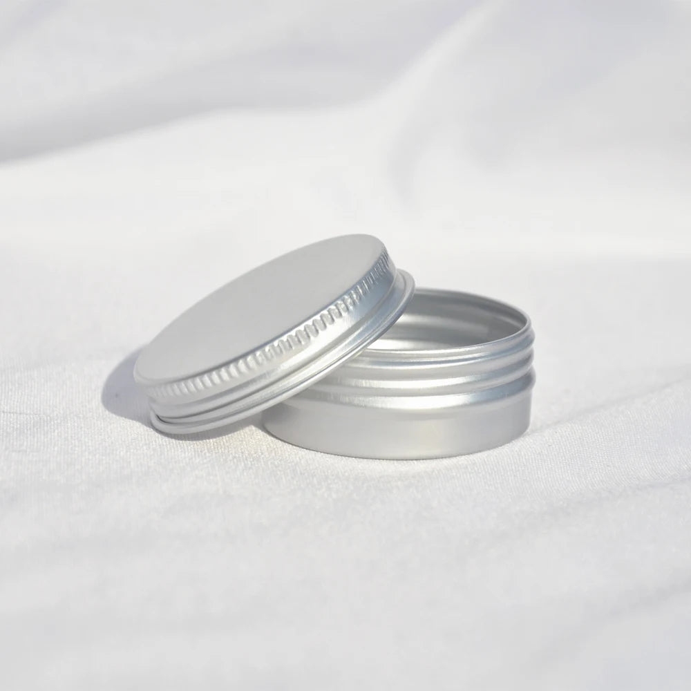 Open silver aluminum tin showing screw threads and removable lid