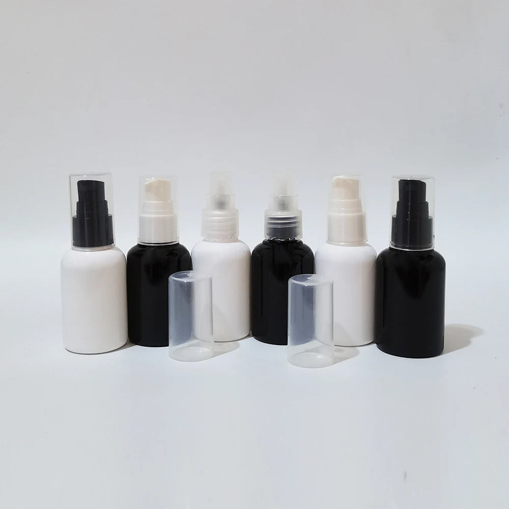 Black and white empty bottles with different pump colors and clear protective covers
