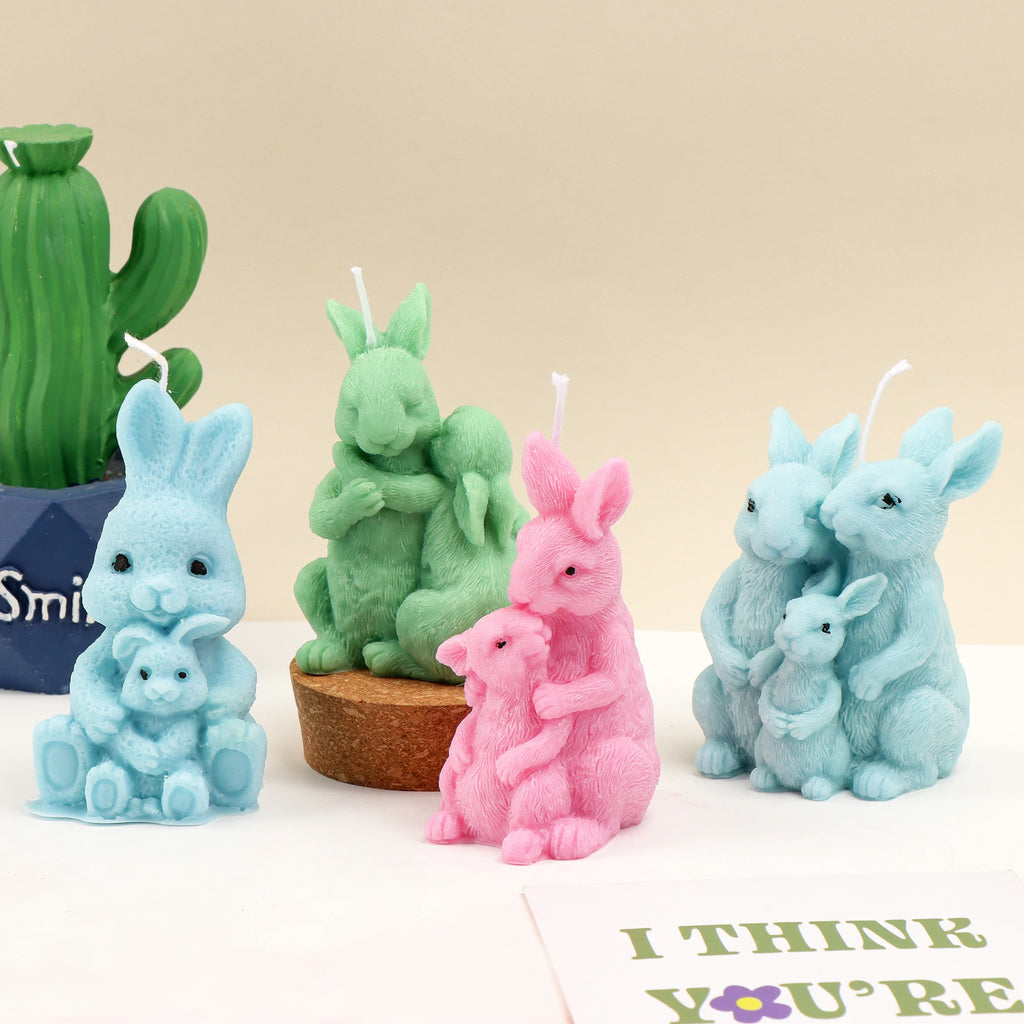 Four pastel rabbit family casting examples with parent-and-young designs beside a cactus decoration