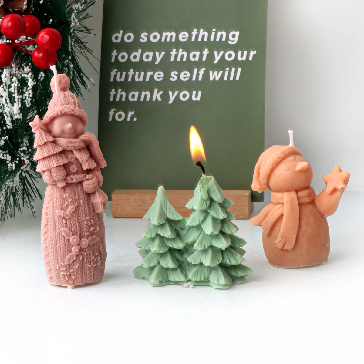 Two snowman example candles beside a three-tree cluster example with one tree lit