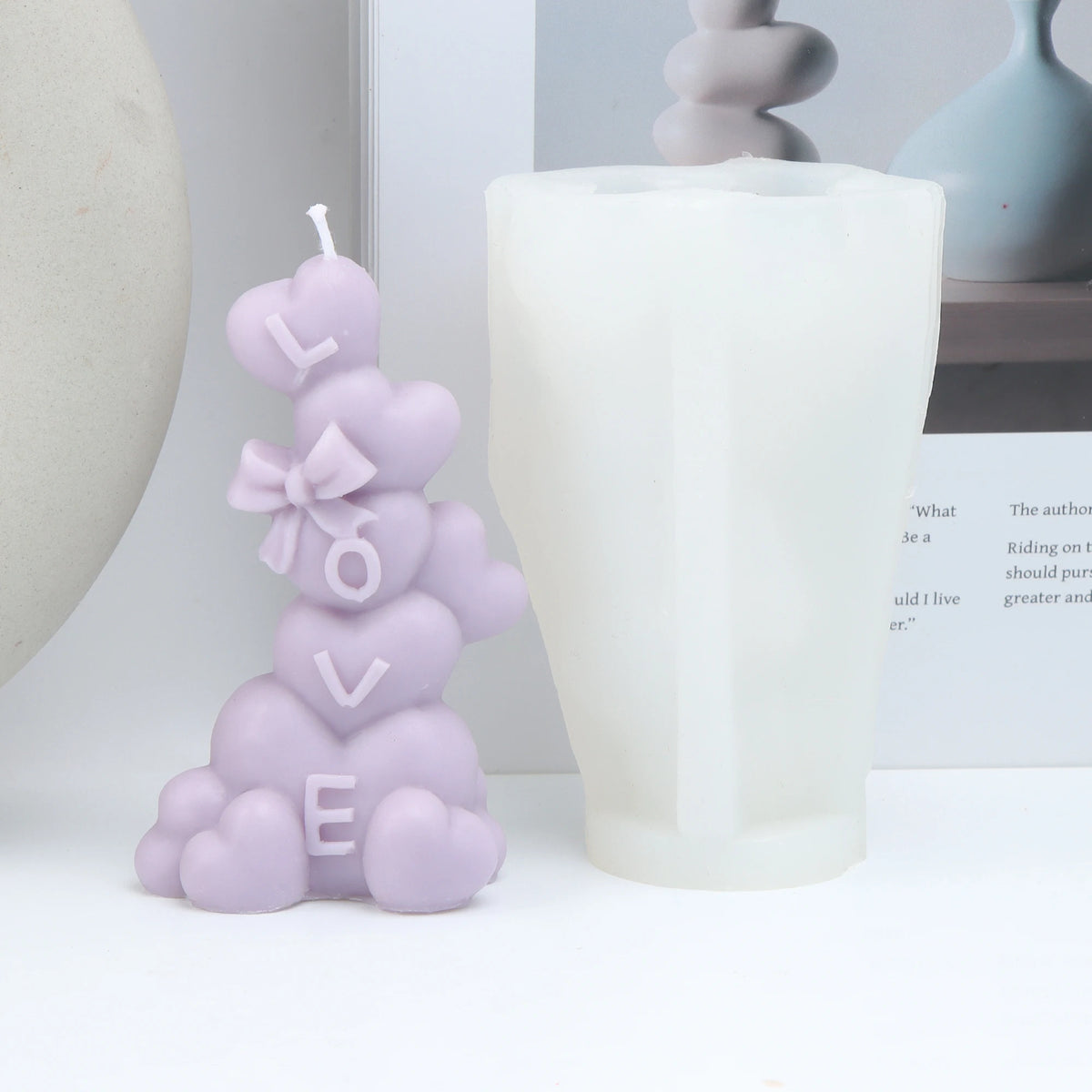 Lavender LOVE-letter heart pillar example candle beside a white silicone mold