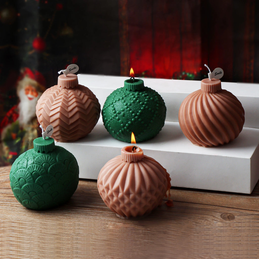 Five pink and green ornament-ball example candles with zigzag, dotted, spiral, fan and lattice textures