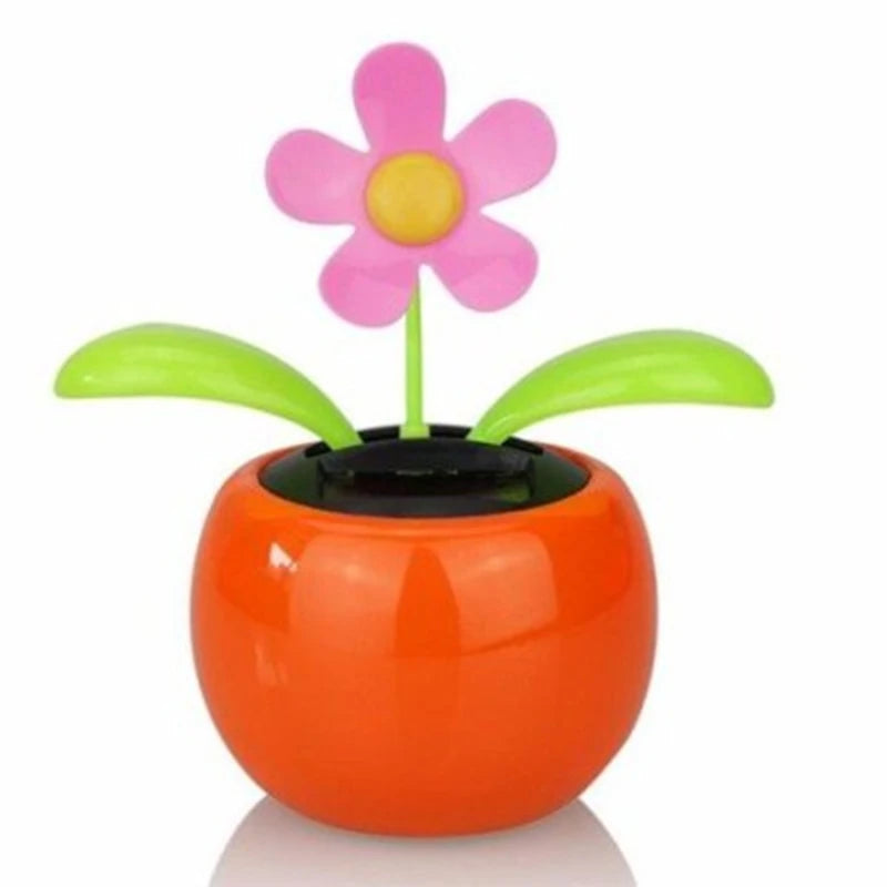 Colorful toy flower in an orange pot on a white background
