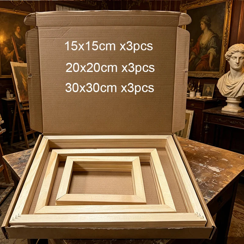 Open cardboard box containing four light wood picture frames in different sizes, with white text on the inside lid reading '15x15cm x3pcs', '20x20cm x3pcs', and '30x30cm x3pcs'. The box is placed on a wooden table in a room with paintings and a bust in the background.