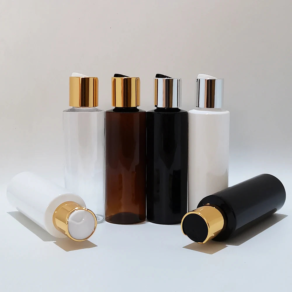 Empty bottles with gold-tone and silver-tone disc caps displayed together