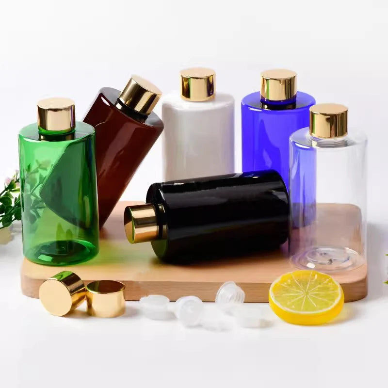 Green, brown, white, blue, clear and black PET bottles with gold-tone screw caps
