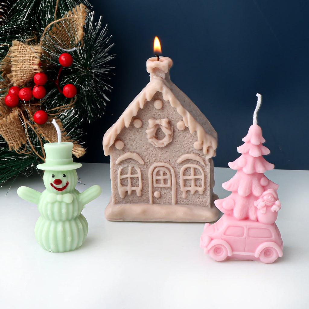 Mint snowman, snowy cottage and pink car carrying a Christmas tree example candles