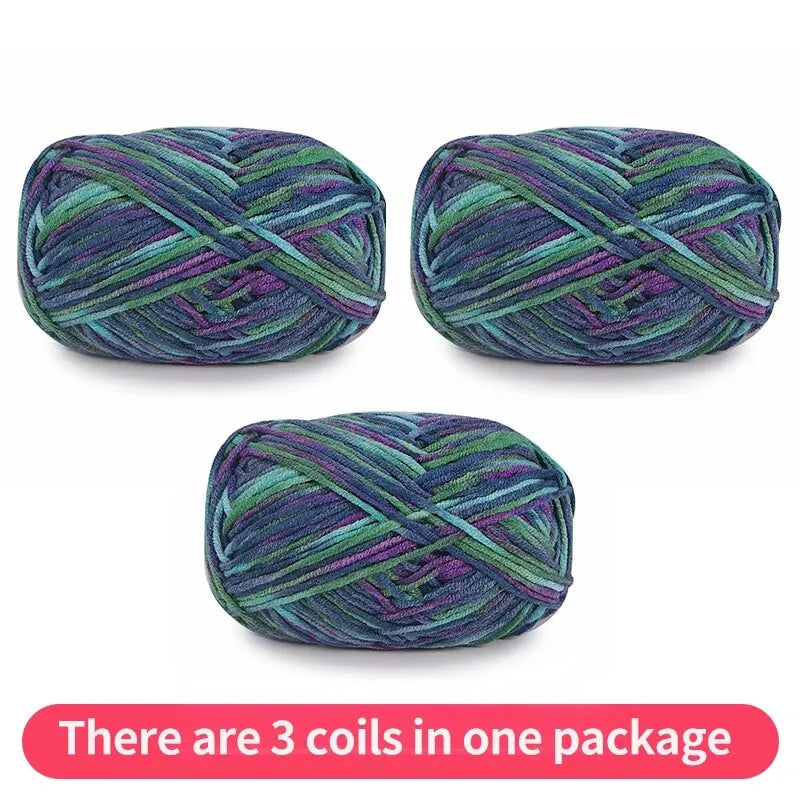 Three dark variegated yarn skeins in teal, blue, green and purple, shown as one package.
