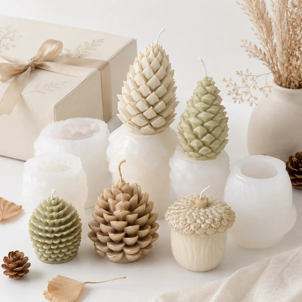 Five pinecone and acorn example candles displayed with their white silicone molds