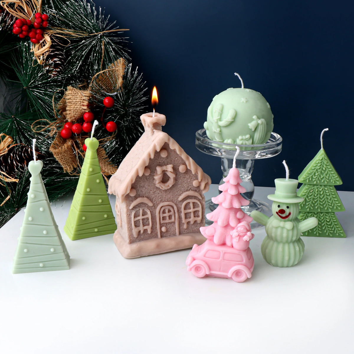 Pastel Christmas example candles with trees, cottage, snowman, car and patterned sphere designs
