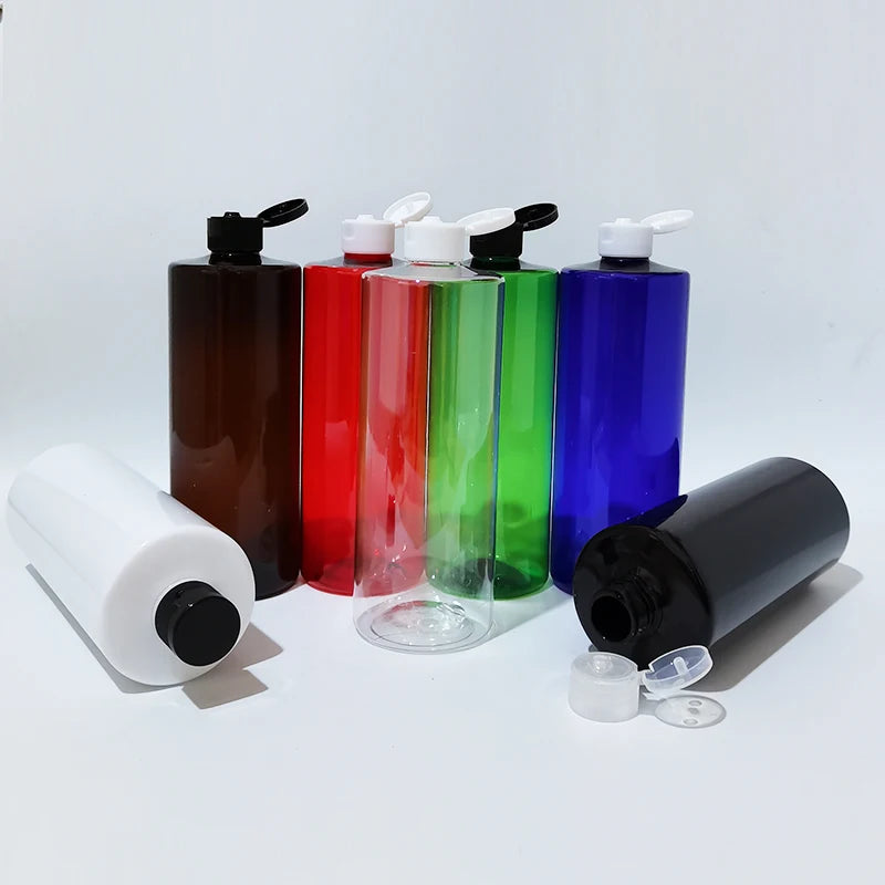 Assorted colored flip-top bottles with open caps and two bottles lying sideways
