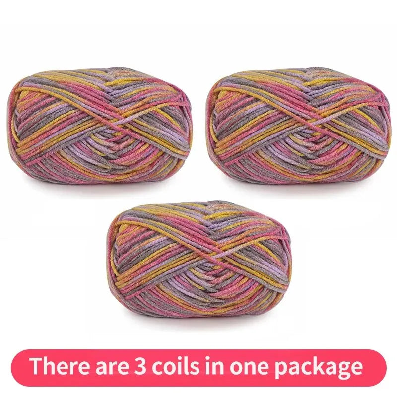 Three variegated yarn skeins in pink, mauve, gray and mustard yellow, shown as one package.