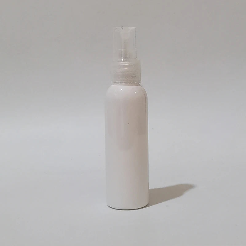 White round spray bottle with clear sprayer and protective cap