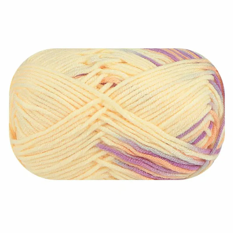 Pale yellow variegated yarn skein with lavender and peach accents on a white background.