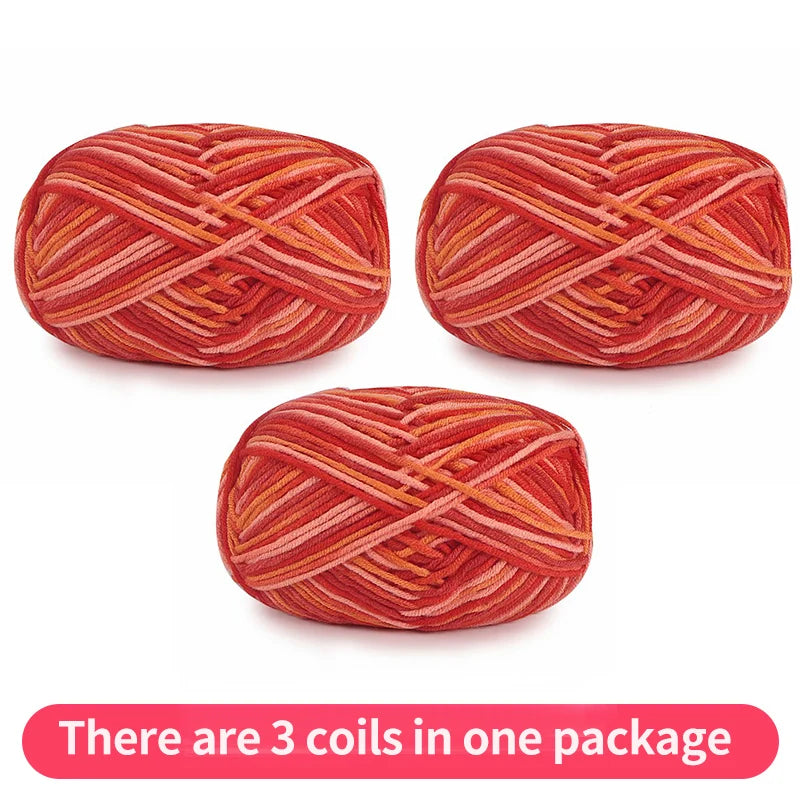 Three coral and orange tonal yarn skeins, shown as one package.