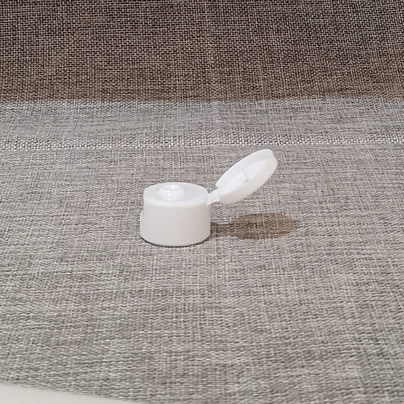 White flip-top bottle cap with hinged lid open