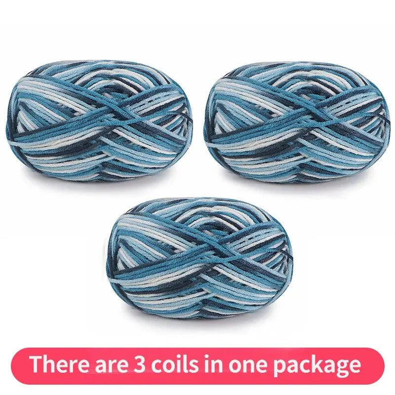 Three variegated yarn skeins in teal, pale blue, gray and white, shown as one package.