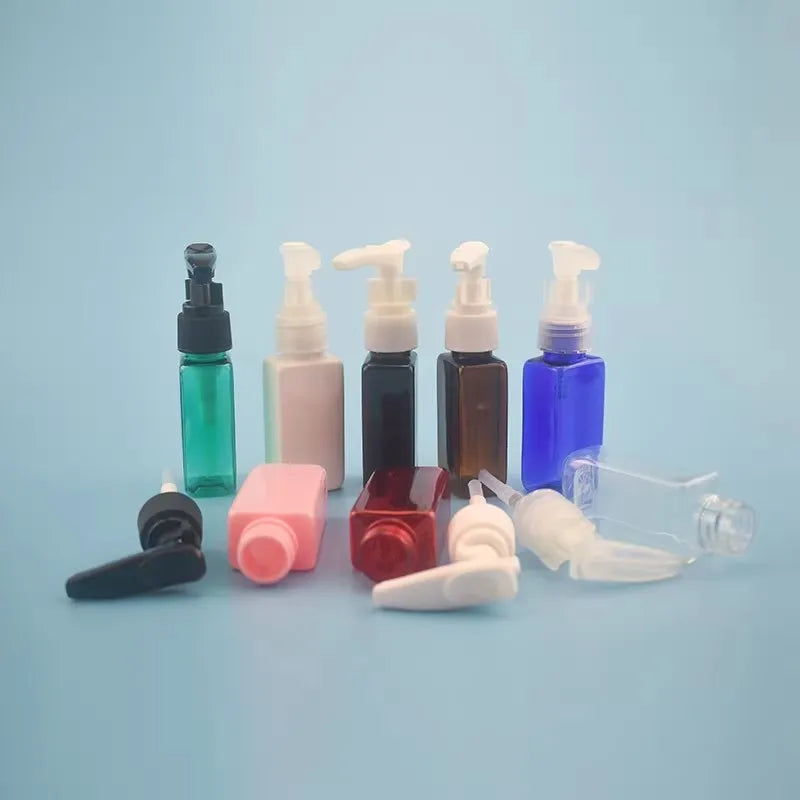 Colored rectangular bottles and loose pump closures displayed on a blue background