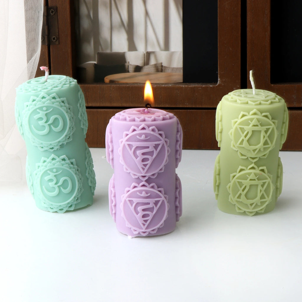 Mint Om-patterned, pink symbol-patterned and pale green star-patterned pillar example candles