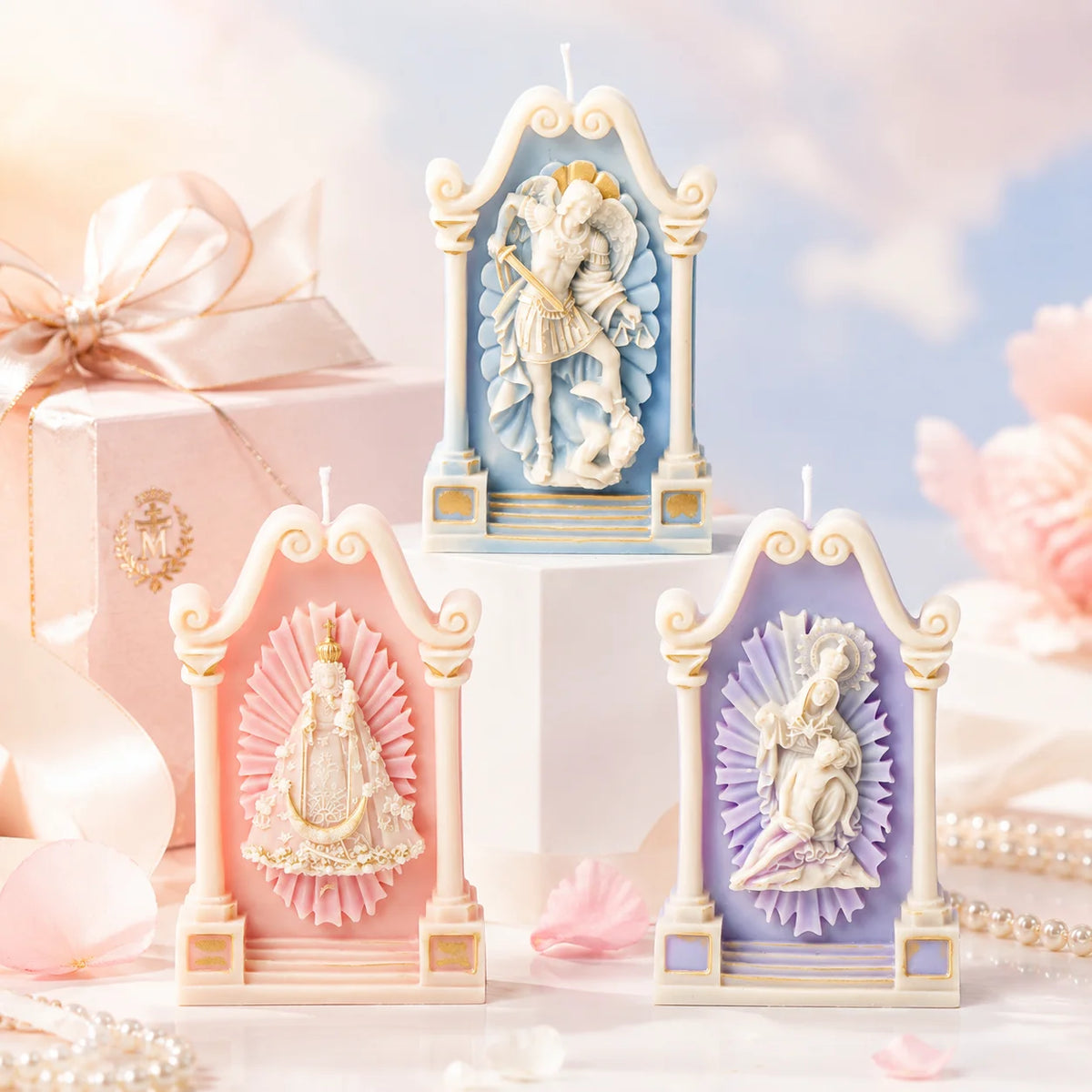 Three pastel shrine casting examples with crowned figure, seated mother and child, and winged warrior reliefs