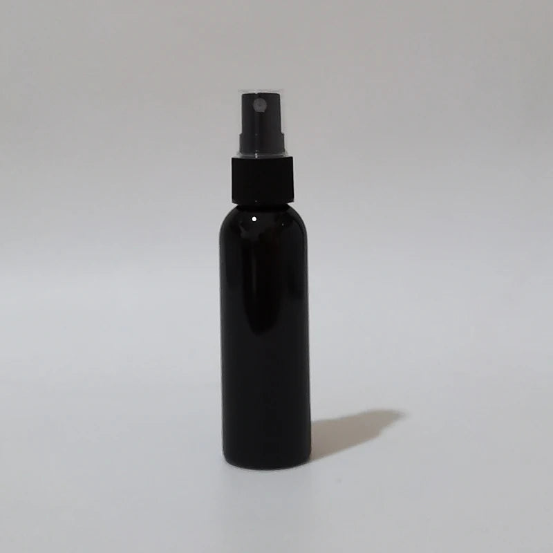 Black round spray bottle with black sprayer and clear protective cap
