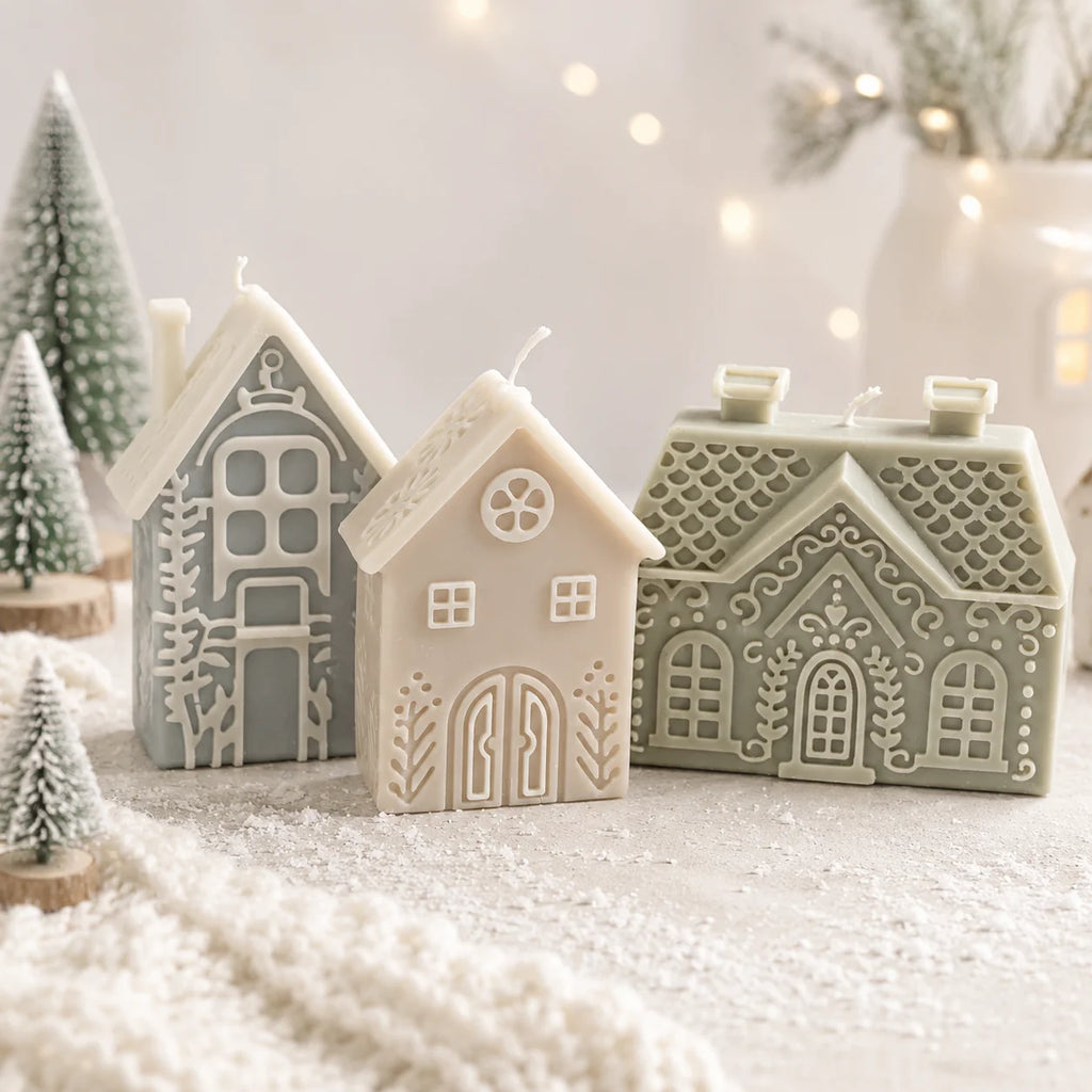 Three Nordic winter house example candles in ivory and muted green with raised window and roof details