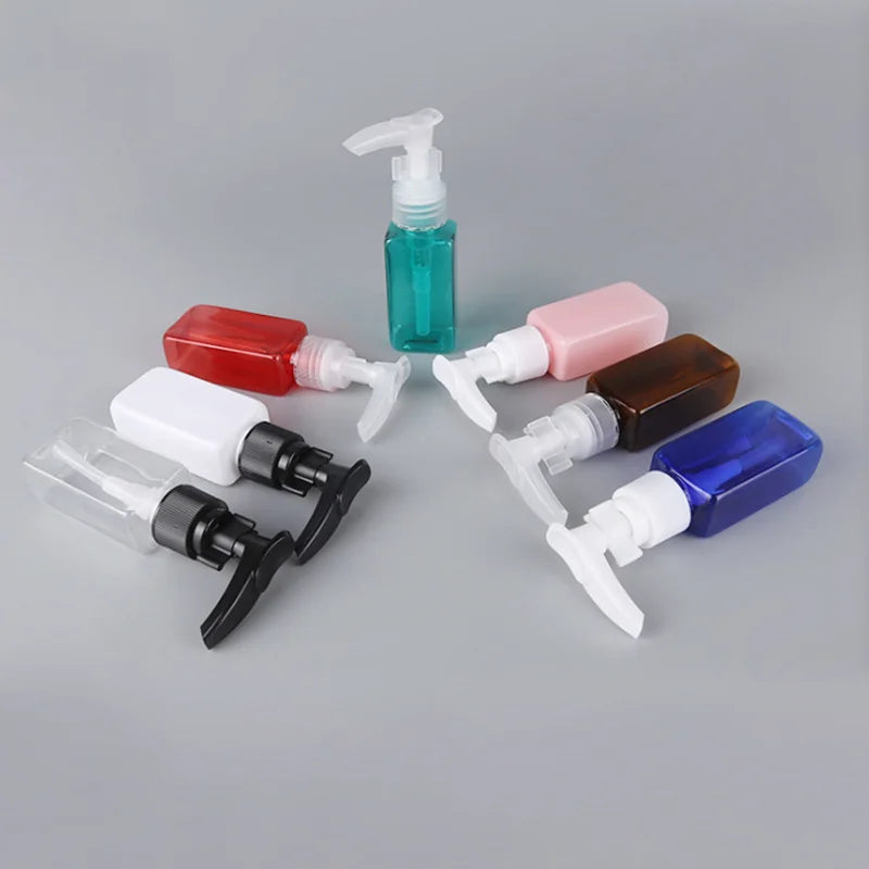 Assorted colored rectangular pump bottles with black, white and clear pump heads