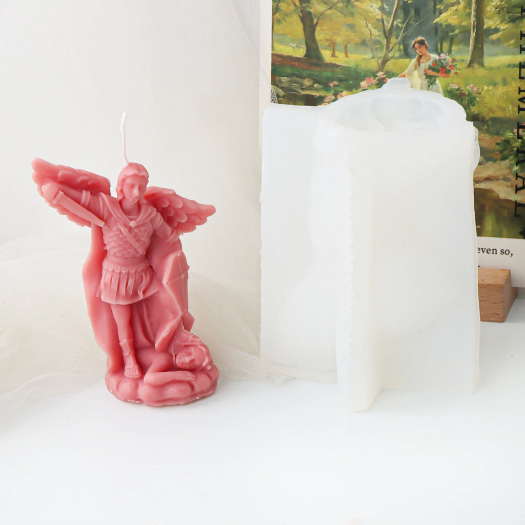 Pink winged archangel example candle beside its white silicone mold