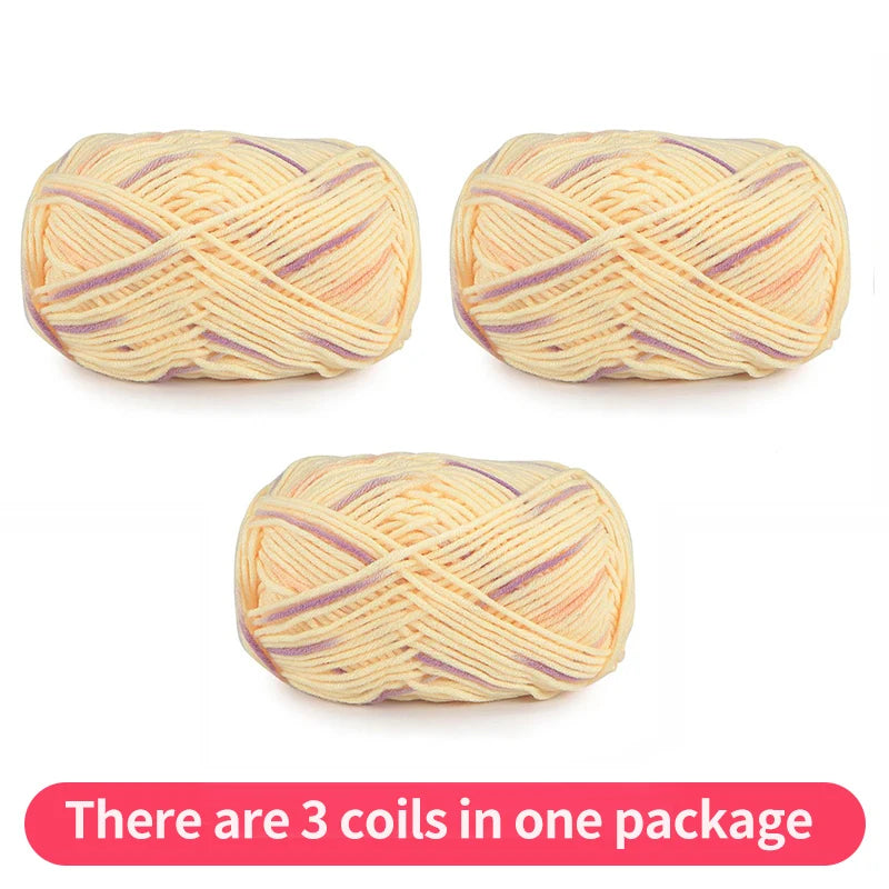 Three pale yellow yarn skeins with lavender and peach accents, shown as one package.